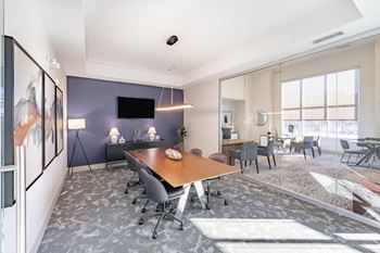 Meeting space with large table and chairs and flat screen tv at Sycamore at Tyvola, Charlotte