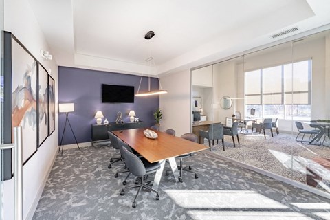 Meeting space with large table and chairs and flat screen tv at Sycamore at Tyvola, Charlotte, NC