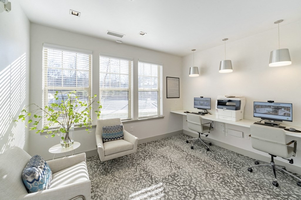 an office with three computers and a chair and a window at Sycamore at Tyvola, Charlotte, 28217