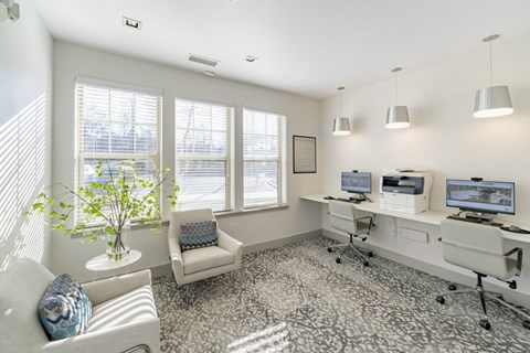 an office with three computers and a chair and a window at Sycamore at Tyvola, Charlotte, 28217