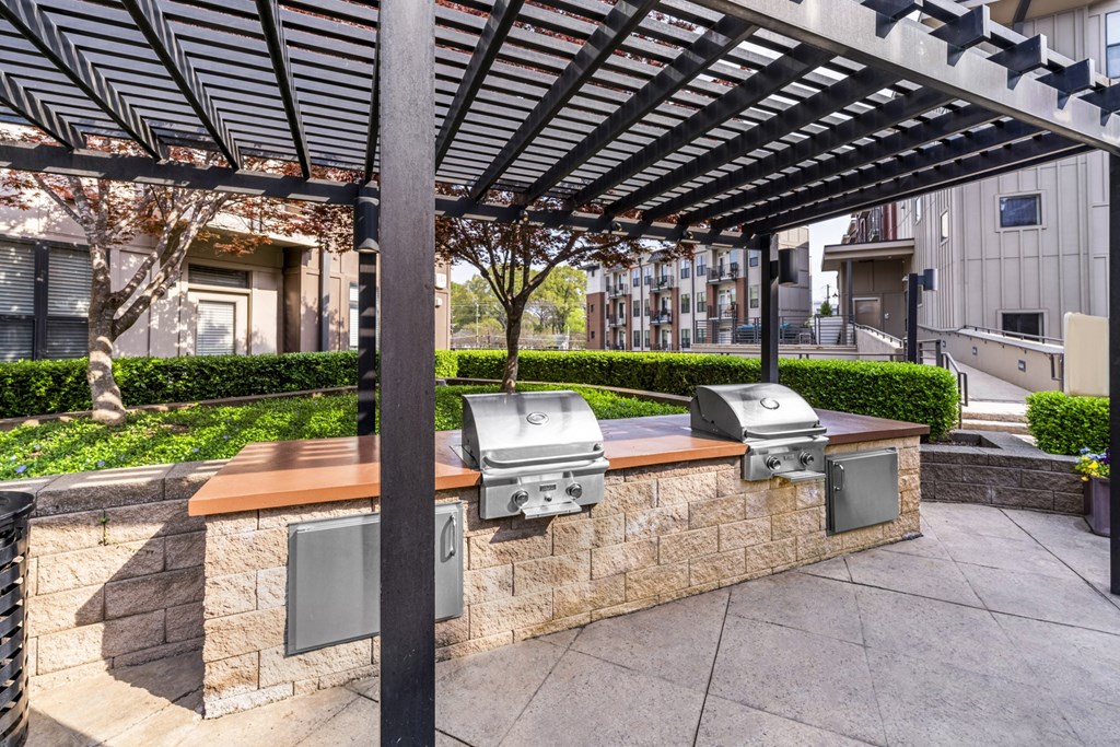 bbq area with a stone wall and a pergola at Park and Kingston, Charlotte, NC, 28203