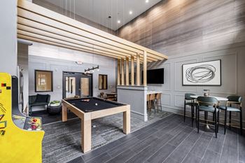 a games room with a pool table and a tv at Park & Kingston, Charlotte, NC 
