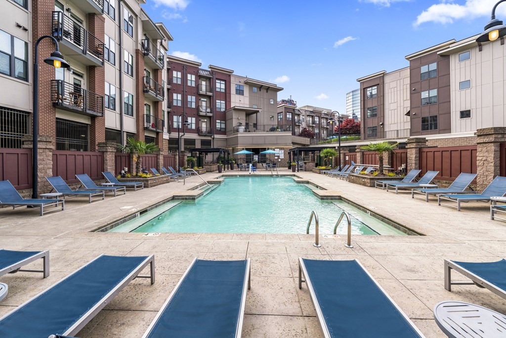 our apartments have a large pool and lounge chairs in front of our building at Park and Kingston, Charlotte, NC