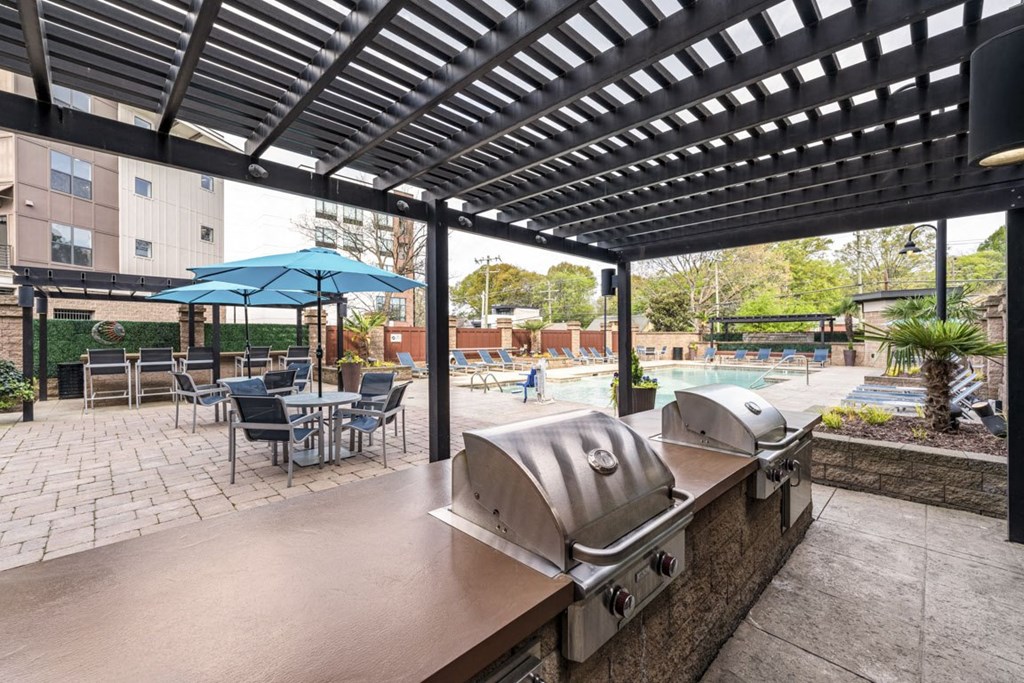 a patio with a grill and tables with umbrellas  at Park and Kingston, Charlotte, NC, 28203