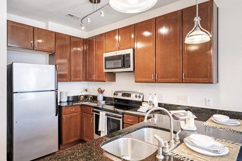 a kitchen with stainless steel appliances and wooden cabinets