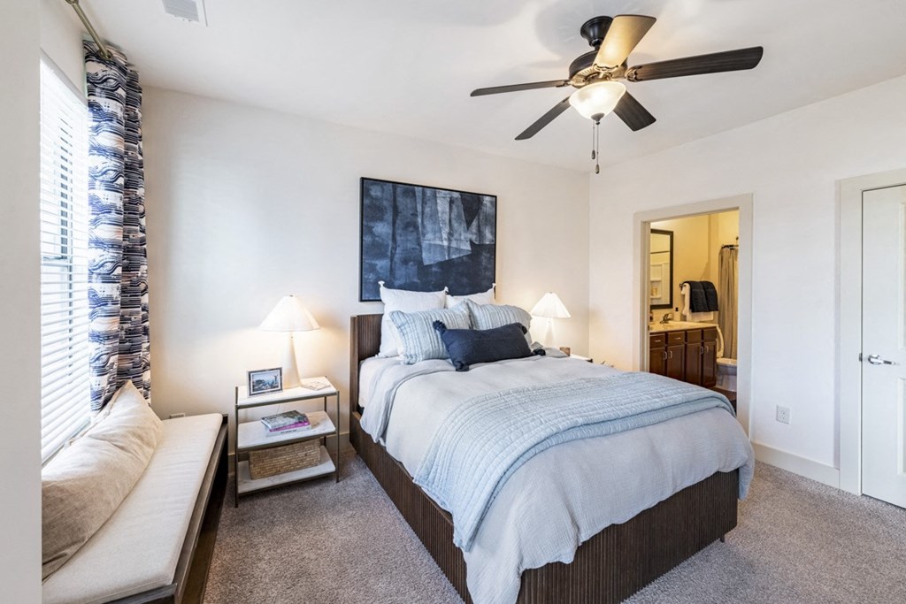 a bedroom with a ceiling fan and a bed  at Park and Kingston, Charlotte, North Carolina
