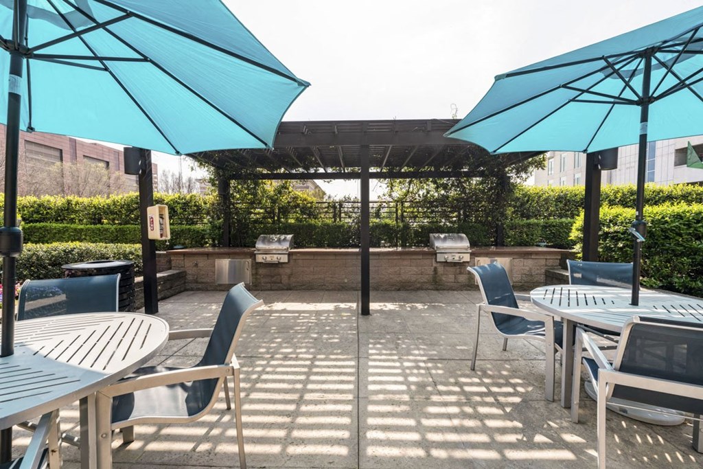 a patio with tables and chairs and umbrellas at Park and Kingston, Charlotte, NC