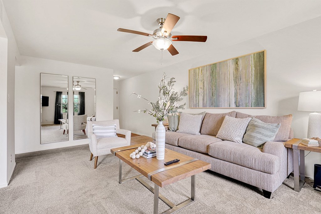a living room with a couch coffee table and a ceiling fan  at Courthouse Square Apartments, Towson, MD, 21286