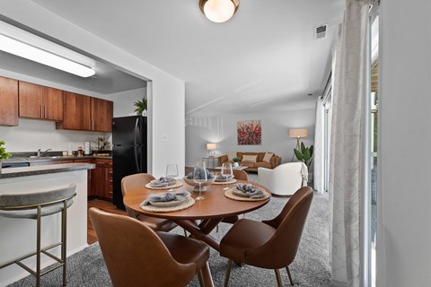 A modern dining room with a wooden table and chairs.