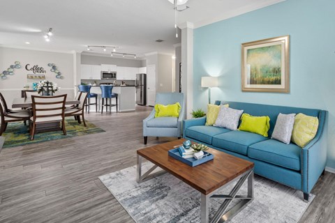 A living room with a blue couch and a coffee table.