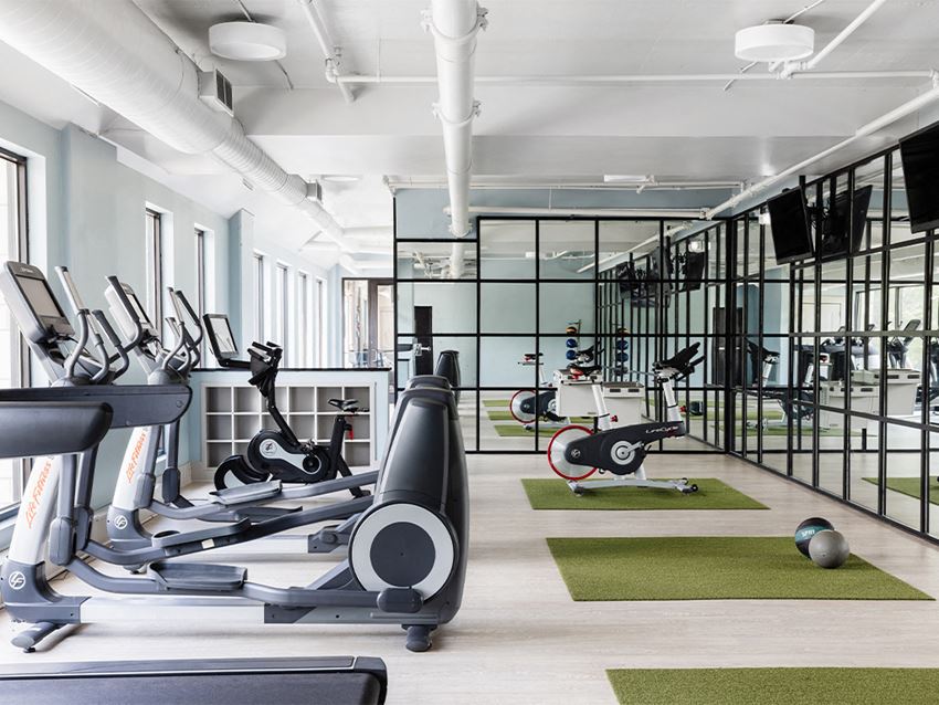 Fitness Center with cardio equipment Fitness Center with cardio equipment at St. Marys Square Apartments, Raleigh, NC - Photo Gallery