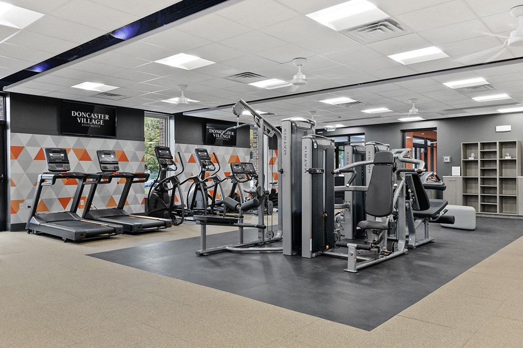 a gym with cardio machines and other exercise equipment at Doncaster Village Apartments, Parkville, Maryland
