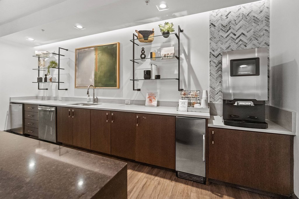 A modern kitchen with dark wood cabinets and stainless steel appliances at 1010 Dilworth Apartments, Charlotte, North Carolina