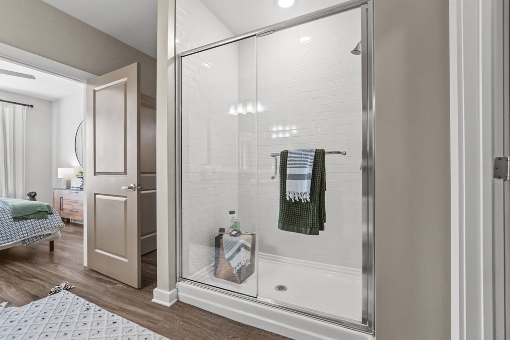 A bathroom with a glass shower door and a towel hanging on it at 1010 Dilworth Apartments, Charlotte, NC, 28204