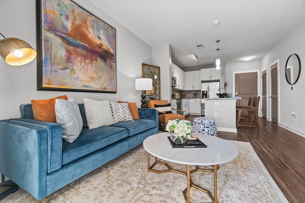 A blue couch with a white table in front of it at 1010 Dilworth Apartments, North Carolina, 28204