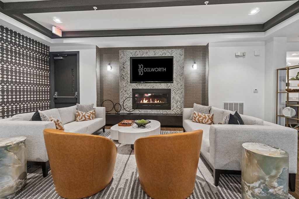 A modern sitting room with a fireplace and a flatscreen TV at 1010 Dilworth Apartments, Charlotte, NC, 28204