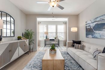 a living room with a white couch and a ceiling fan at Bristol at New Riverside, South Carolina