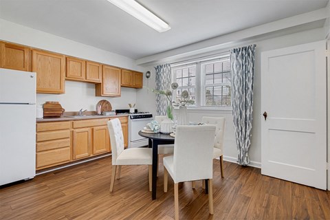 a kitchen and dining room with a table and chairs