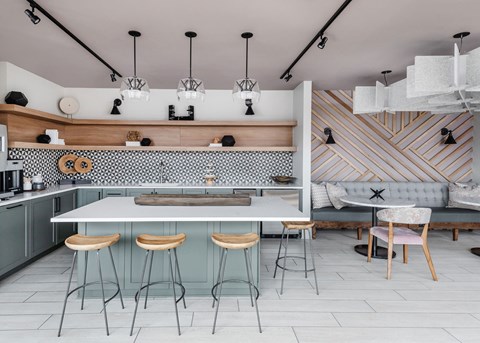a kitchen with a white counter top and stools