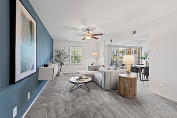 a living room with a couch and a ceiling fan  at Courthouse Square Apartments, Towson, MD, 21286