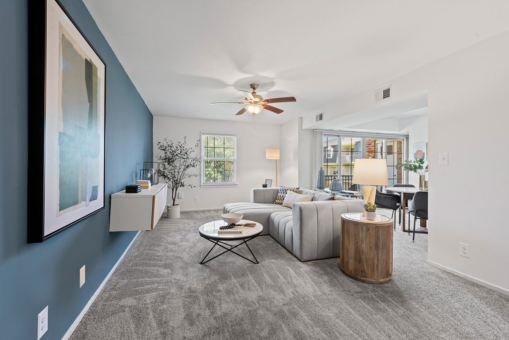 a living room with a couch and a ceiling fan at Courthouse Square Apartments, Towson