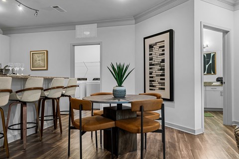A dining room with a table set for four.