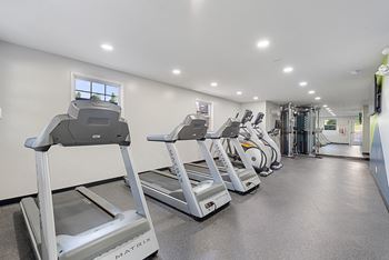 a row of treadmills in a gym with cardio equipment at Courthouse Square Apartments, Towson