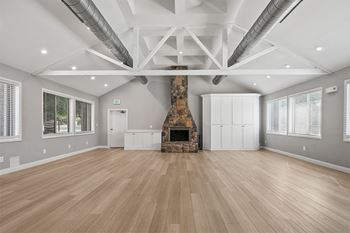 a large living room with a fireplace and wooden floors at McDonogh Township Apartments, Maryland, 21117