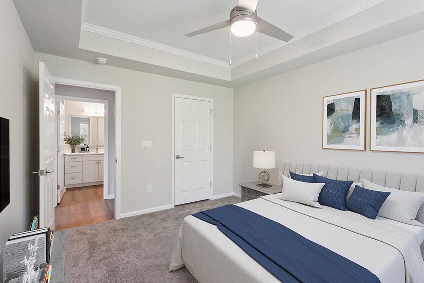 a bedroom with a large bed and a ceiling fan a bedroom with a large bed and a ceiling fan at The Bluestone Apartments, South Carolina