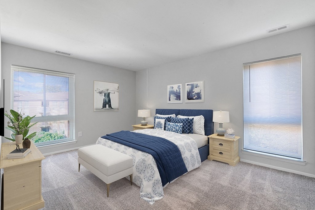 a bedroom with a bed and two windows at Westwinds Apartments, Annapolis, MD