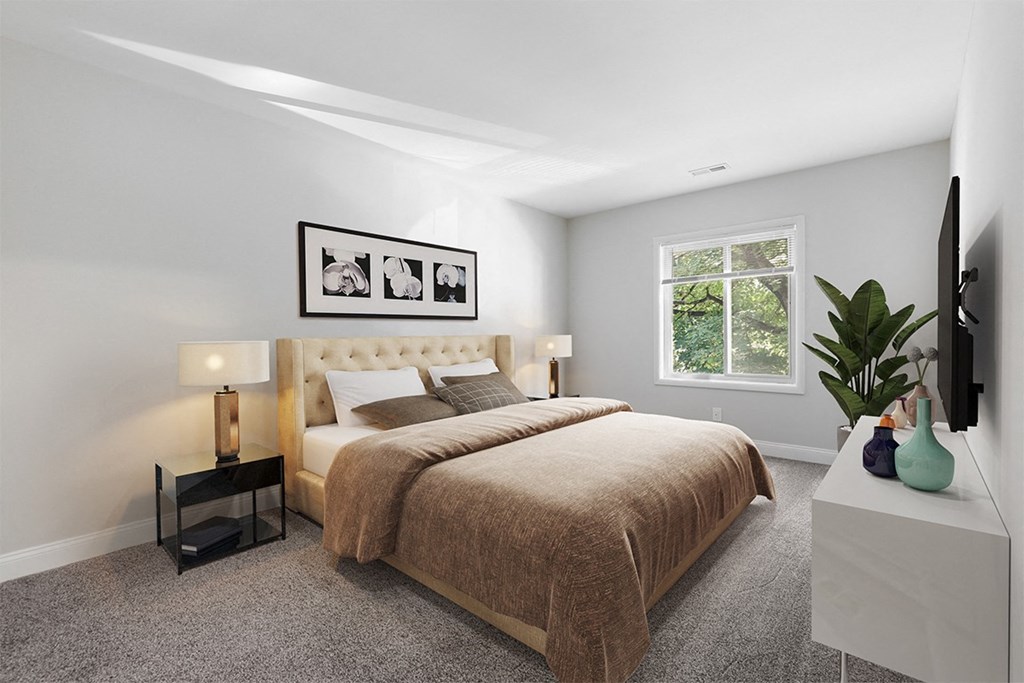 a bedroom with grey walls and a large bed  with a brown blanket at Padonia Village Apartments, Timonium MD