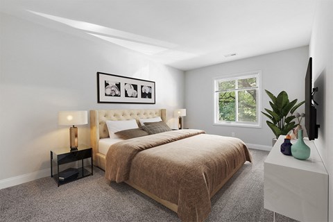 a bedroom with grey walls and a large bed  with a brown blanket at Padonia Village Apartments, Timonium MD