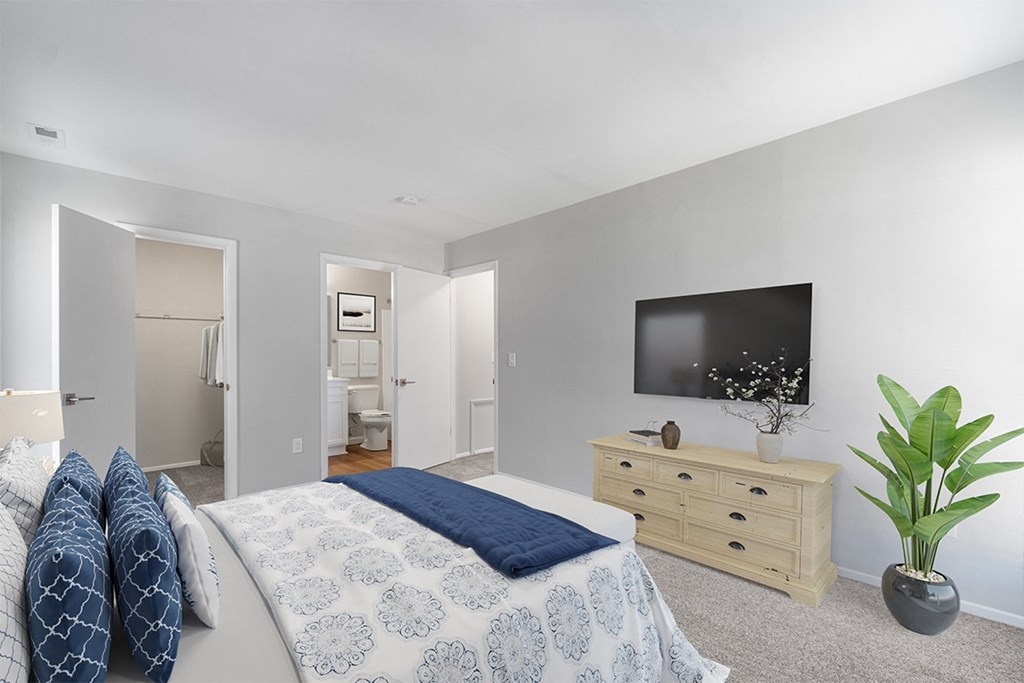 a bedroom with a bed and a tv on the wall at Westwinds Apartments, Annapolis, MD
