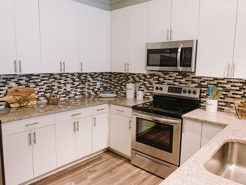Kitchen with tile backsplash at Sycamore at Tyvola, Charlotte, North Carolina