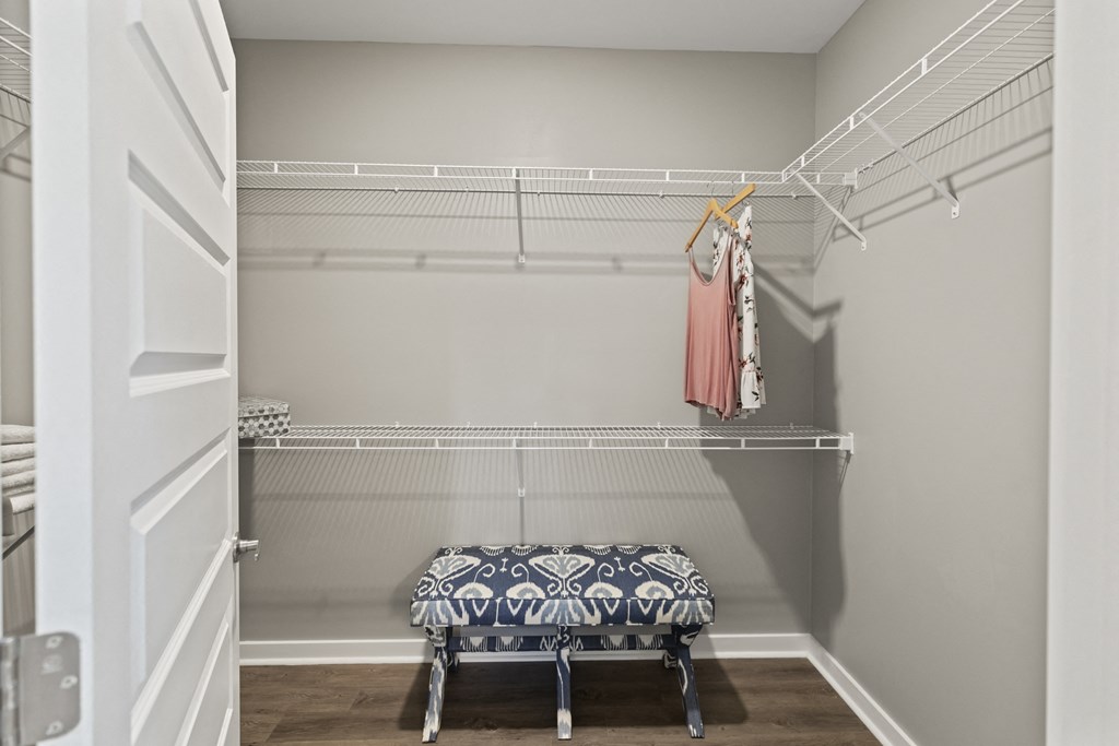 a walk in closet with a and a rack with clothes at Central Island Square, Daniel Island, 29492