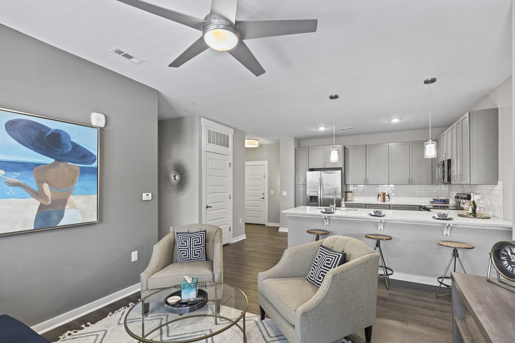 an open living room and kitchen with a ceiling fan at Central Island Square, South Carolina