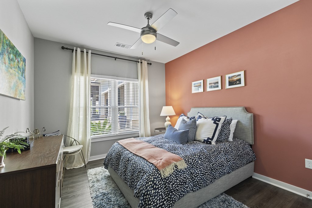 a bedroom with a bed and a ceiling fan at Central Island Square, Daniel Island, South Carolina