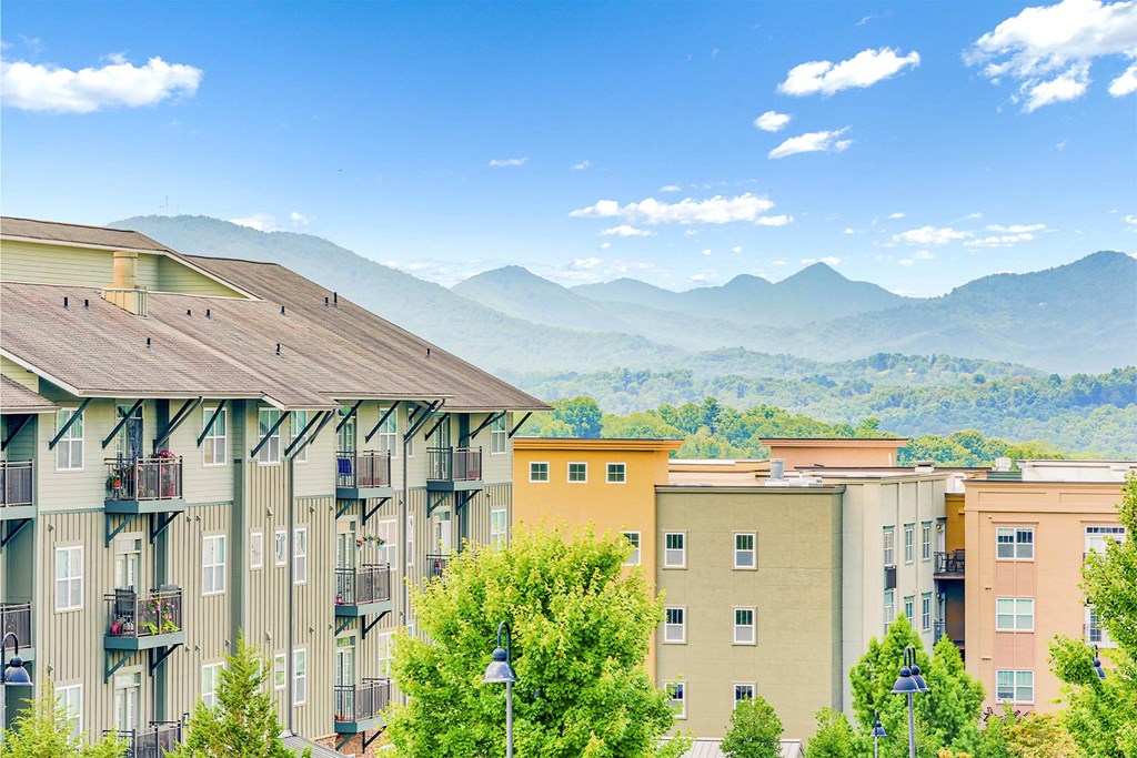 Apartment buildings with balconies overlooking a mountain range at The Lofts at Reynolds Village Apartments, North Carolina