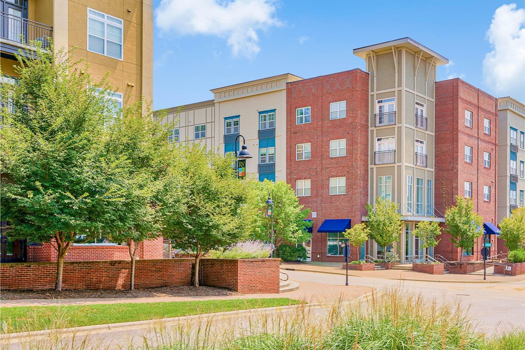 A building with a red brick wall in front of it at The Lofts at Reynolds Village Apartments, Asheville, North Carolina