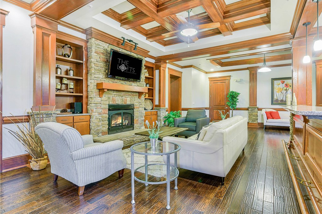 A living room with a fireplace and a flat screen TV at The Lofts at Reynolds Village Apartments, North Carolina, 92627