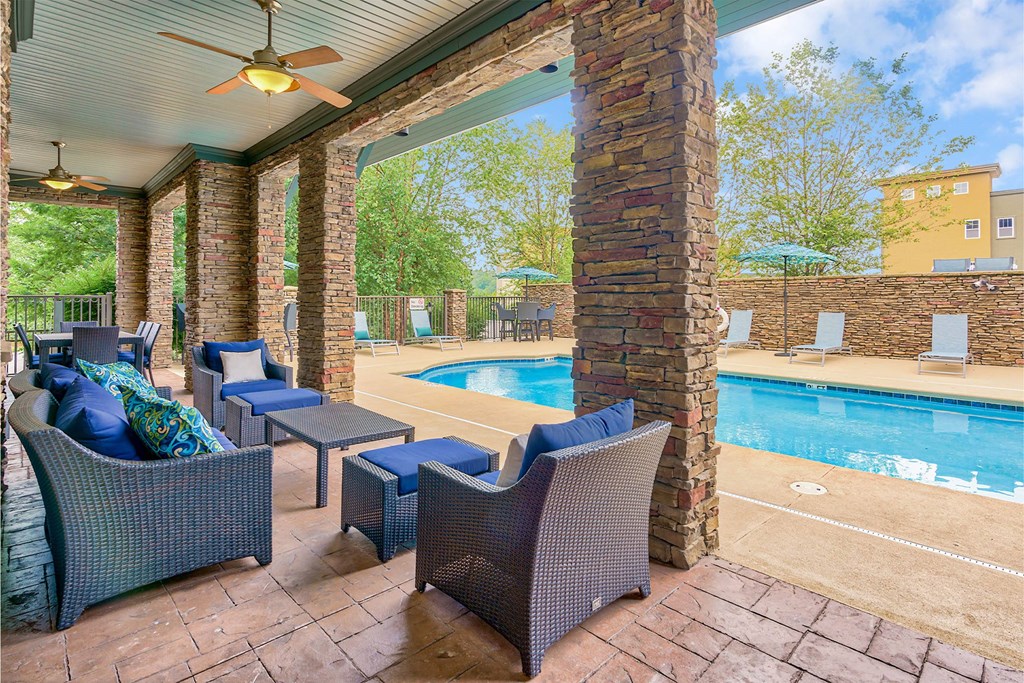 A patio with a pool and a table with chairs at The Lofts at Reynolds Village Apartments, Asheville, NC, 92627
