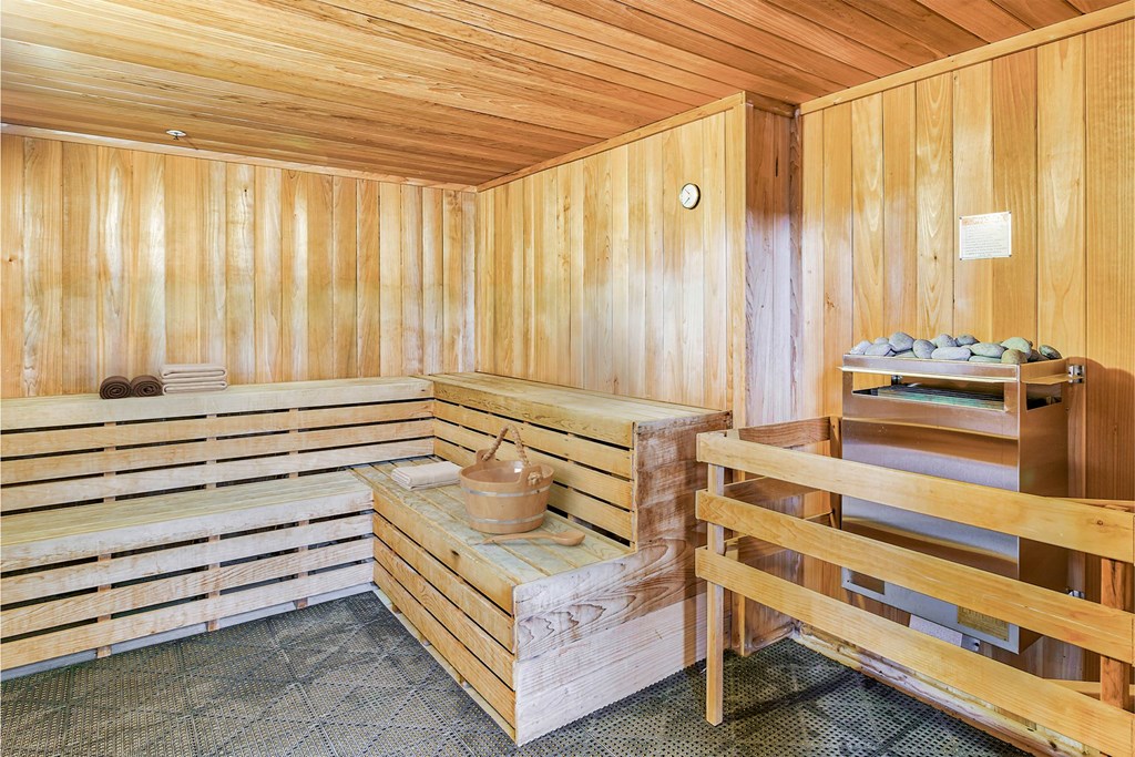 A wooden sauna with a bench and a table at The Lofts at Reynolds Village Apartments, Asheville