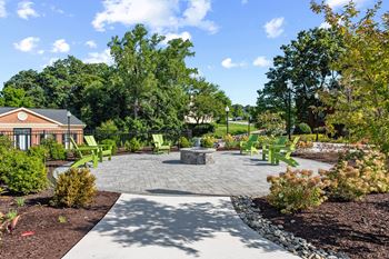 a patio with chairs and a fire pit at Courthouse Square Apartments, Maryland