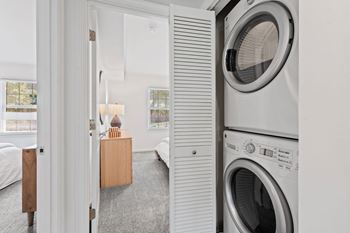 a small laundry room with a washing machine and a dryer at Courthouse Square Apartments, Maryland, 21286