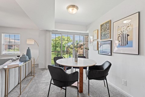 a dining room with a table and chairs and a window at Courthouse Square Apartments, Towson, 21286