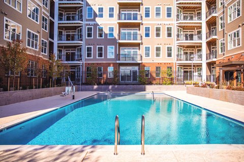 empty pool in front of an apartment building at Dartmoor Place at Oxford Square Apartments, Hanover, MD 21076