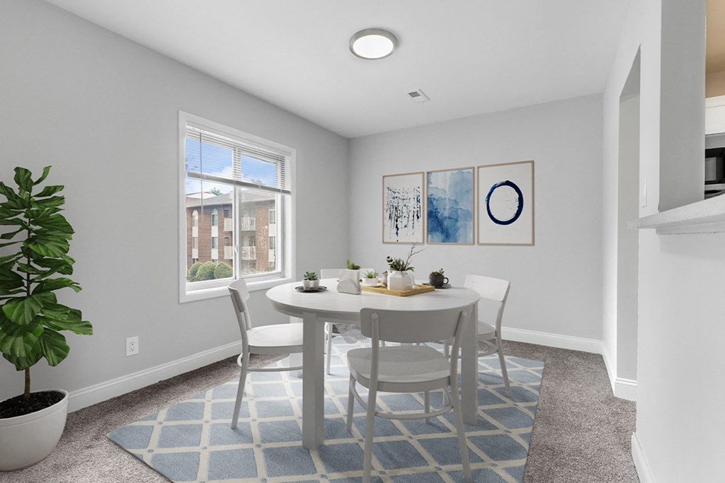 a dining room with a table and chairs at Padonia Village Apartments, Timonium MD