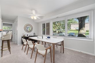 a dining room with a large window and a ceiling fan a dining room with a large window and a ceiling fan at Falls Village Apartments, Baltimore MD
