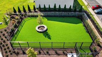 an aerial view of a dog park with green grass and a fountain at Courthouse Square Apartments, Towson, MD