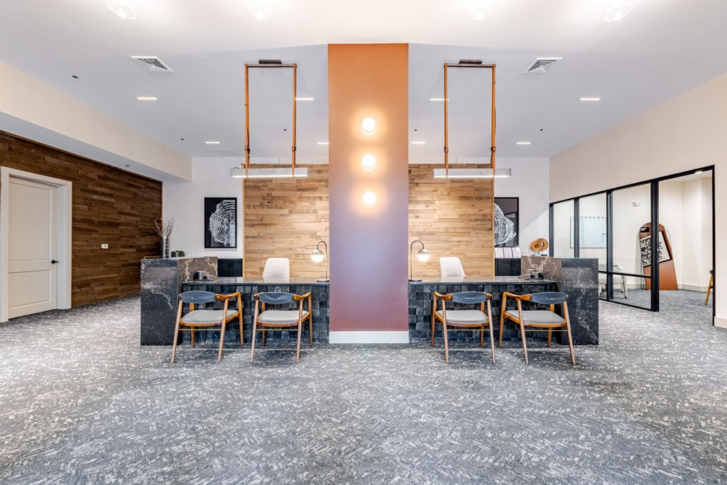 A modern leasing office with a long table and chairs at The Edison Lofts Apartments, Raleigh, North Carolina